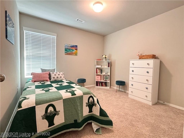bedroom featuring baseboards, visible vents, and carpet flooring