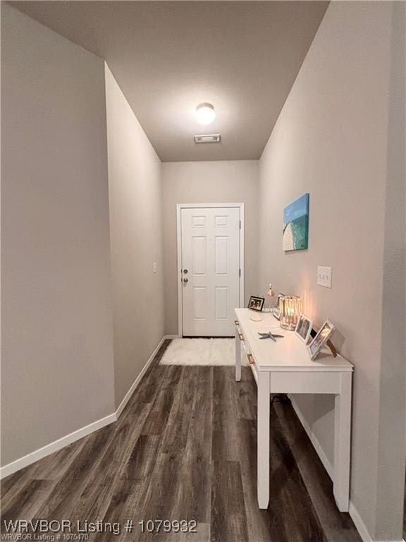 doorway to outside featuring dark wood-style floors, visible vents, and baseboards