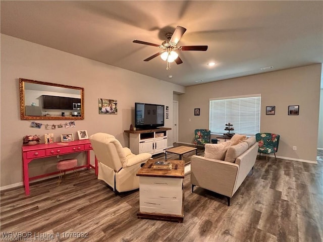 living area featuring baseboards, visible vents, ceiling fan, and dark wood-type flooring