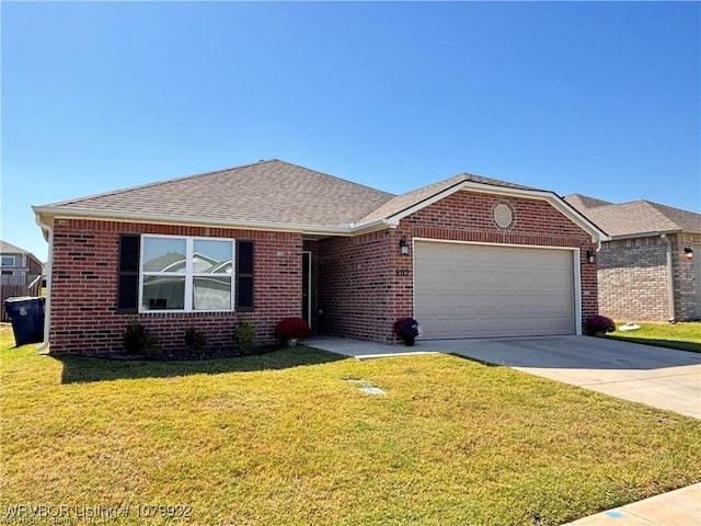 single story home with driveway, a front yard, an attached garage, and brick siding