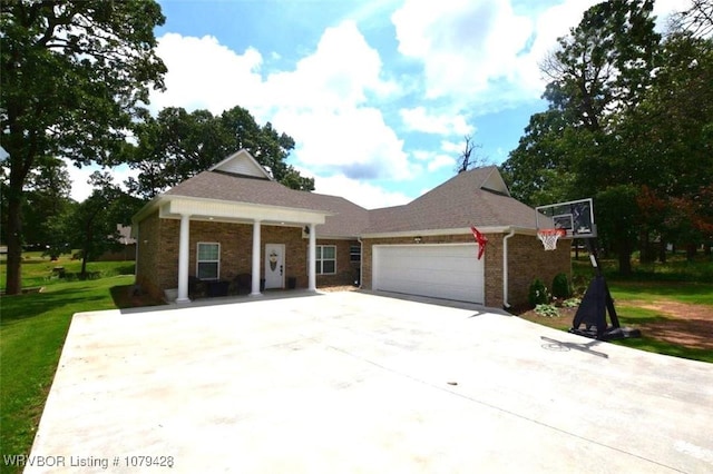1111 Ridge Dr, Stilwell, OK 74960 - view of front of house with brick siding, an attached garage, a front lawn, and concrete driveway
