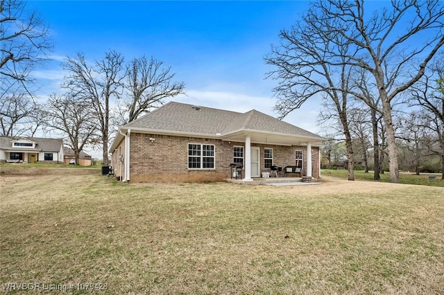 1111 Ridge Dr, Stilwell, OK 74960 - rear view of house featuring brick siding, a yard, and a patio