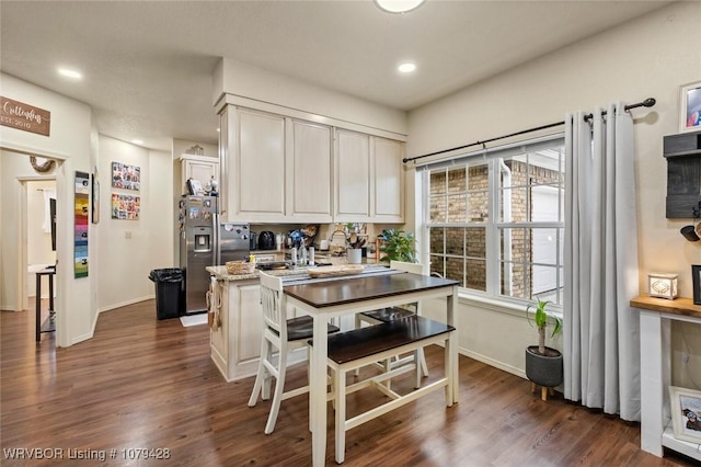 1111 Ridge Dr, Stilwell, OK 74960 - kitchen with stainless steel fridge with ice dispenser, baseboards, dark wood-style flooring, recessed lighting, and white cabinetry