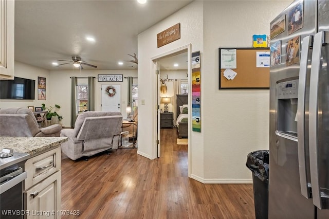 1111 Ridge Dr, Stilwell, OK 74960 - kitchen with stainless steel fridge with ice dispenser, a ceiling fan, open floor plan, dark wood-type flooring, and baseboards