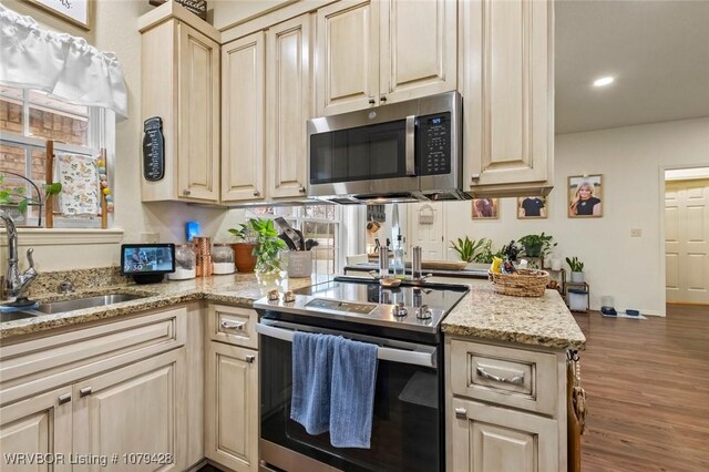 1111 Ridge Dr, Stilwell, OK 74960 - kitchen with appliances with stainless steel finishes, a sink, wood finished floors, light stone countertops, and recessed lighting