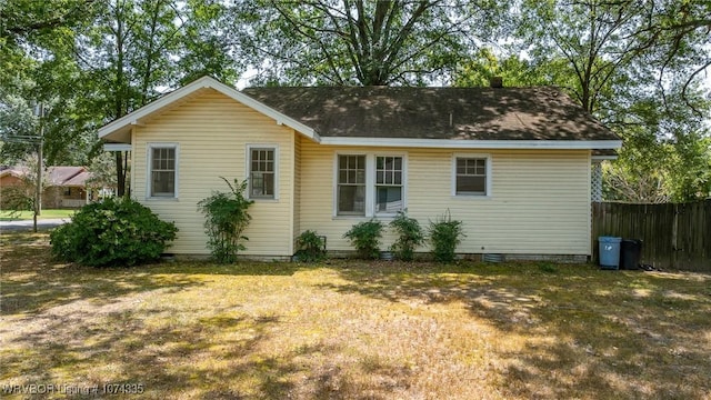 rear view of house with a lawn