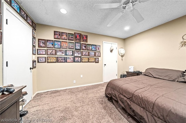 carpeted bedroom featuring ceiling fan and a textured ceiling