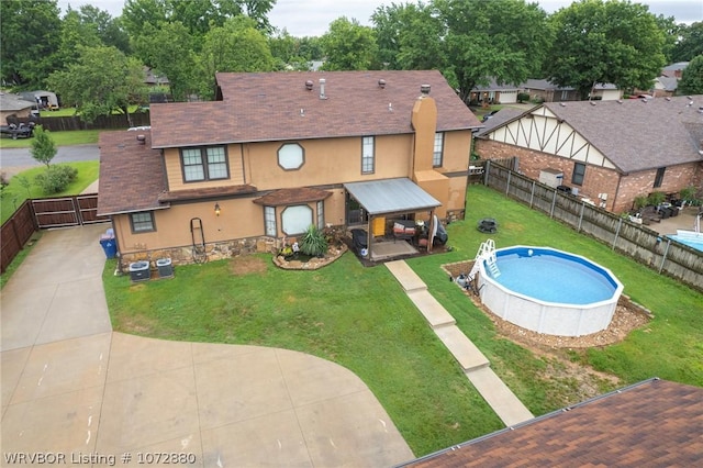 view of pool with a lawn