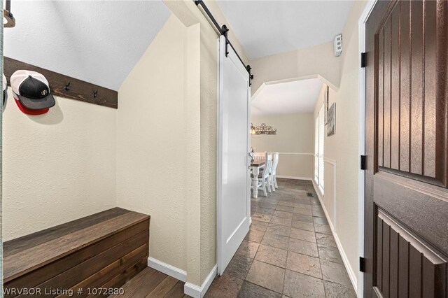 hallway featuring a barn door