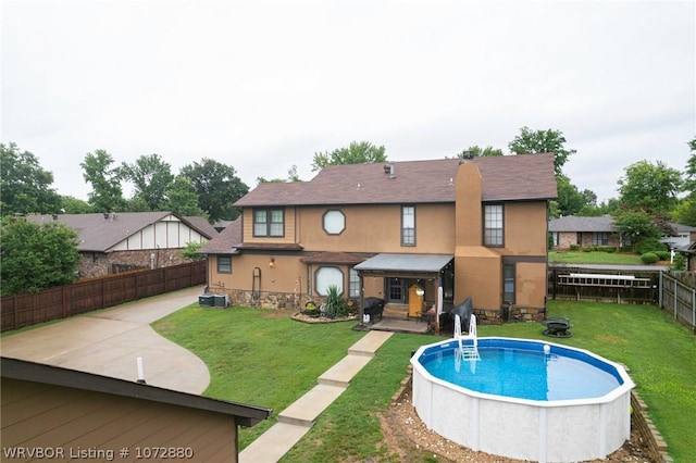 view of pool with a yard and cooling unit