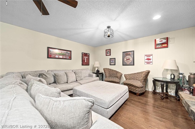 living room featuring a textured ceiling and dark hardwood / wood-style floors