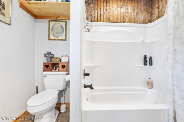 bathroom with hardwood / wood-style floors, shower / tub combo, and toilet