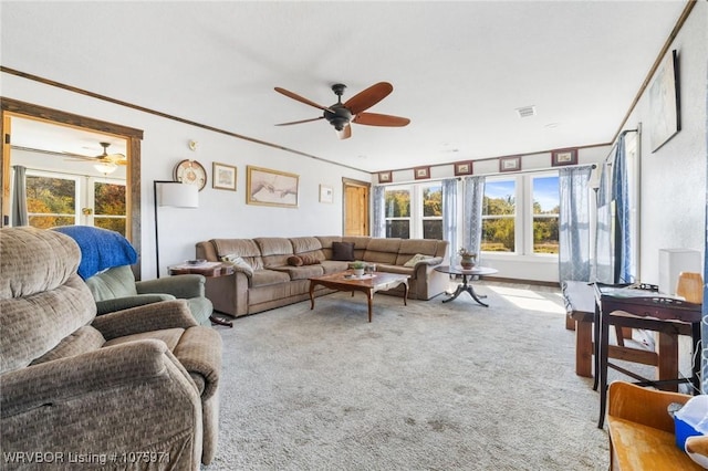 living room with light carpet, french doors, ceiling fan, and ornamental molding