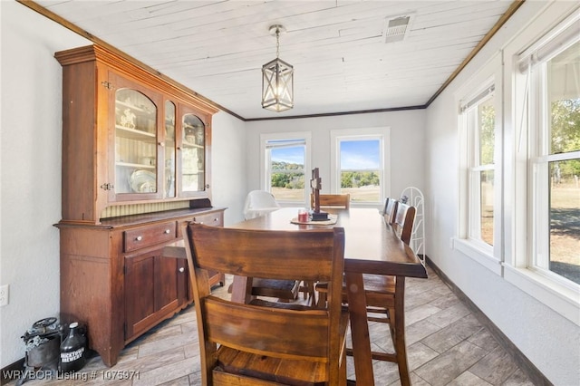 dining room featuring hardwood / wood-style floors, plenty of natural light, ornamental molding, and wood ceiling