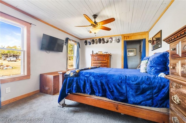 carpeted bedroom featuring ceiling fan, crown molding, and wood ceiling