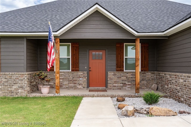112 Countryside Way, Pocola, OK 74902 - doorway to property with brick siding, a shingled roof, and a porch