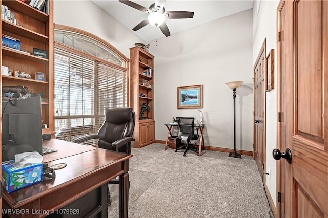home office with ceiling fan, light carpet, and baseboards