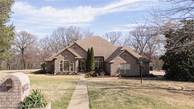 view of front of home featuring a front lawn and brick siding
