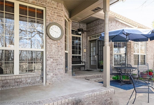 view of patio featuring a ceiling fan and visible vents