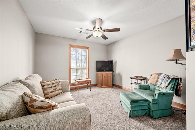 living room featuring baseboards, visible vents, carpet floors, and ceiling fan