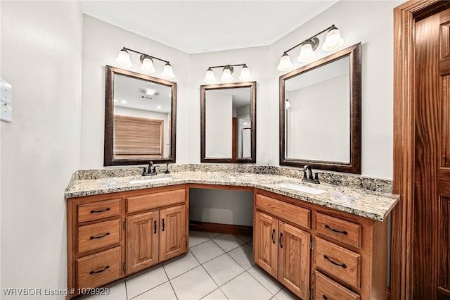 full bath with double vanity, visible vents, tile patterned flooring, and a sink