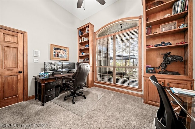 carpeted office space with ceiling fan and vaulted ceiling