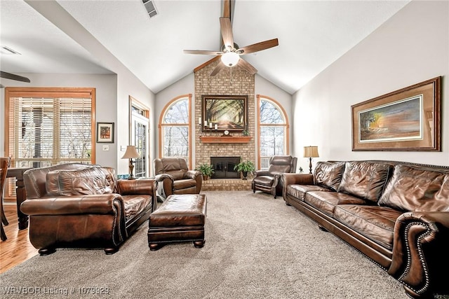 living area with carpet floors, a ceiling fan, visible vents, and a fireplace