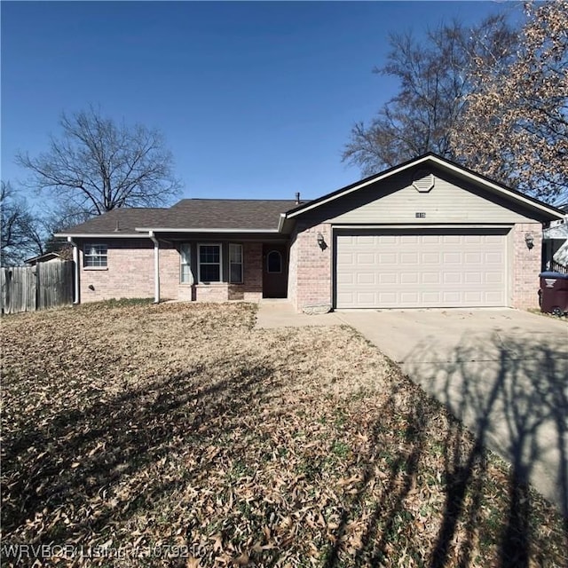 ranch-style home featuring a garage, fence, concrete driveway, and brick siding