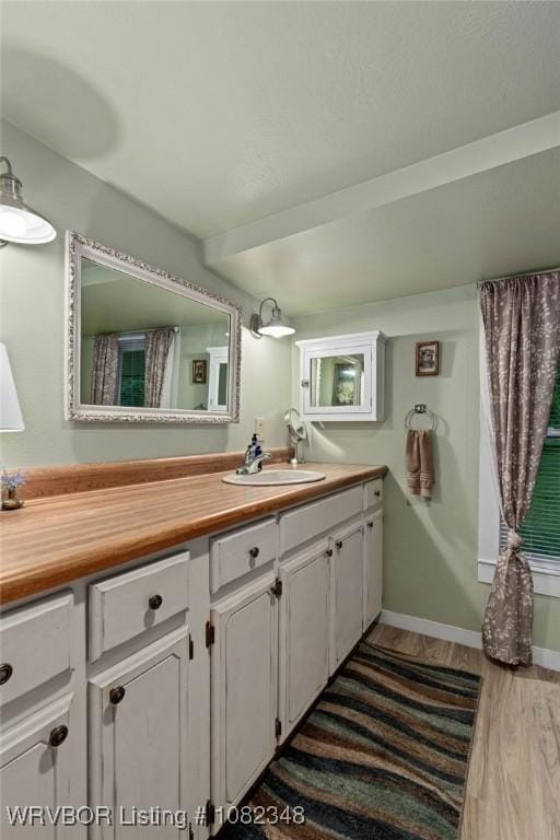 627 Parks Dr, Charleston, AR 72933 - bathroom with wood finished floors and vanity