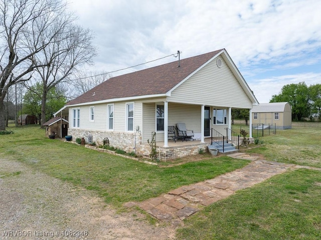 627 Parks Dr, Charleston, AR 72933 - view of front of home with a front lawn, roof with shingles, and a patio