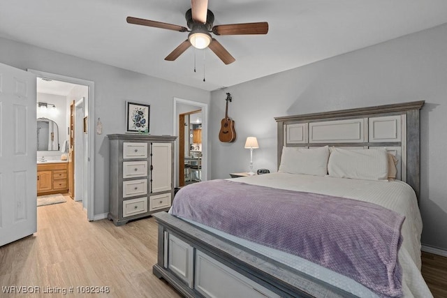 627 Parks Dr, Charleston, AR 72933 - bedroom with light wood-style floors, ceiling fan, and connected bathroom