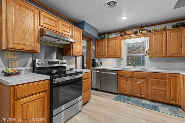 627 Parks Dr, Charleston, AR 72933 - kitchen with stainless steel appliances, under cabinet range hood, and light countertops