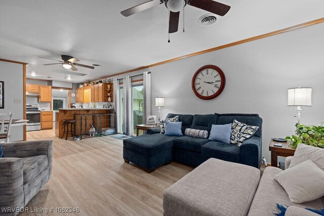 627 Parks Dr, Charleston, AR 72933 - living room with a ceiling fan, ornamental molding, and light wood-style flooring
