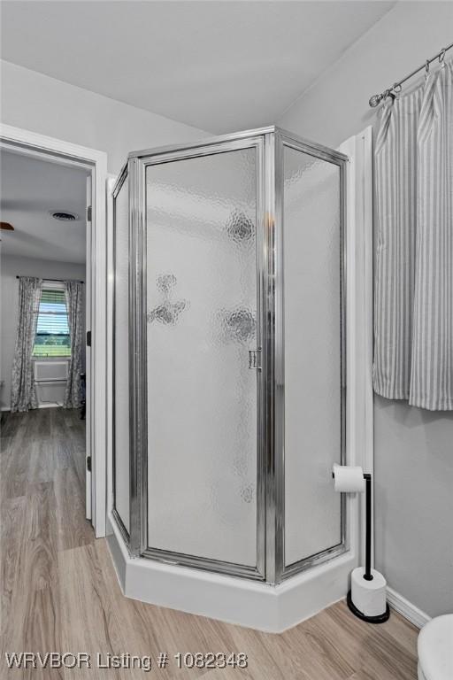 627 Parks Dr, Charleston, AR 72933 - full bath with a shower stall and wood finished floors