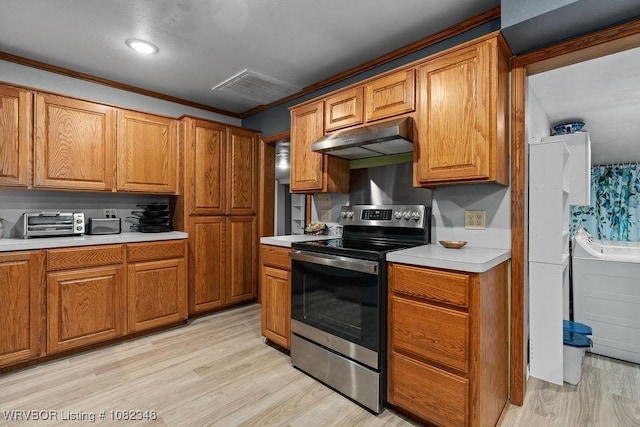 627 Parks Dr, Charleston, AR 72933 - kitchen featuring electric stove, under cabinet range hood, light countertops, brown cabinetry, and ornamental molding