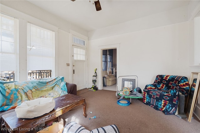 living room featuring a healthy amount of sunlight, carpet floors, and ceiling fan