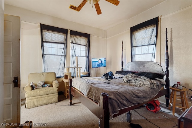 carpeted bedroom with visible vents and ceiling fan