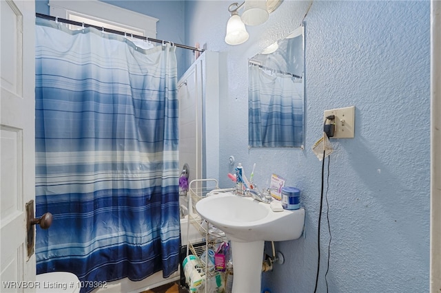 bathroom with a textured wall