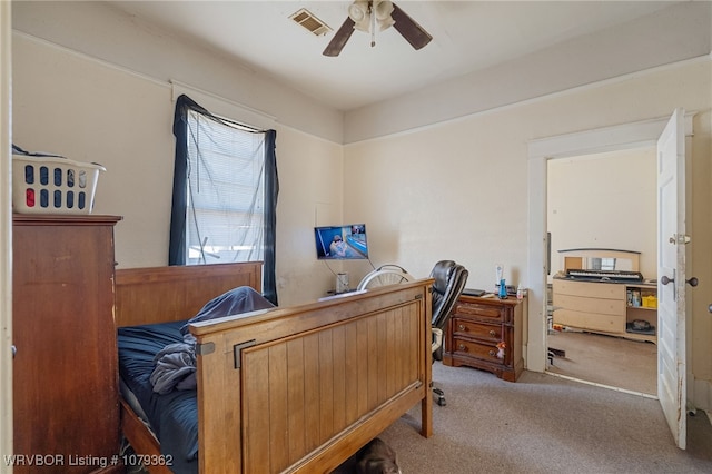 carpeted bedroom featuring a ceiling fan and visible vents