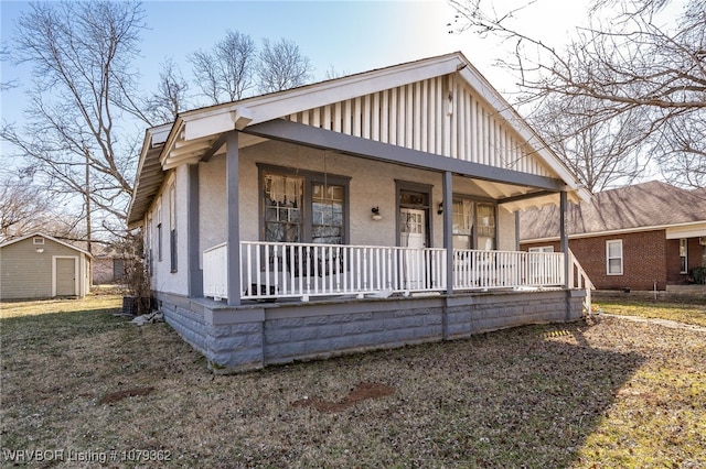 bungalow-style house featuring covered porch and stucco siding