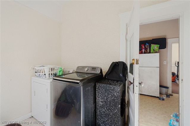 laundry room featuring laundry area, washer and dryer, and light floors