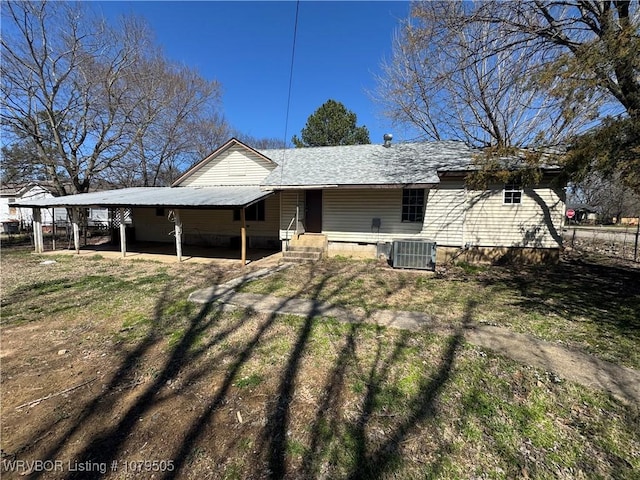 back of property with central air condition unit and roof with shingles