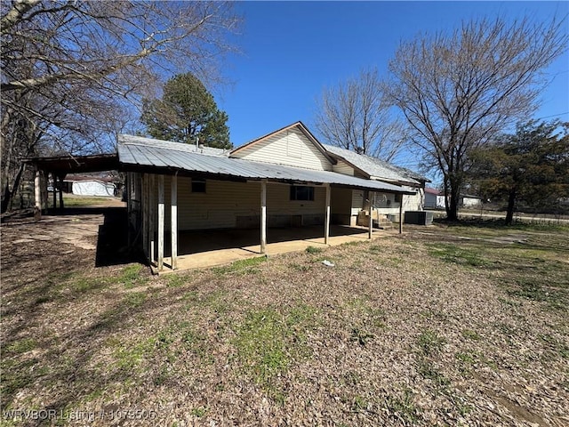 view of home's exterior featuring an attached carport and metal roof