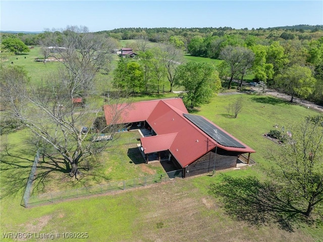 birds eye view of property with a view of trees