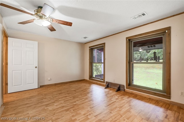 unfurnished room featuring visible vents, ceiling fan, light wood-style flooring, and baseboards