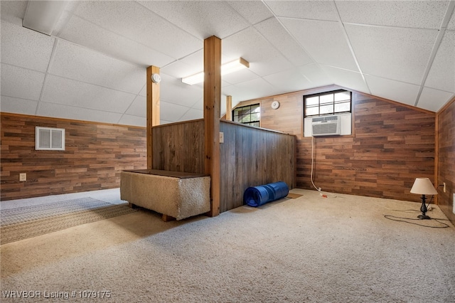 bonus room featuring carpet, wooden walls, visible vents, and cooling unit