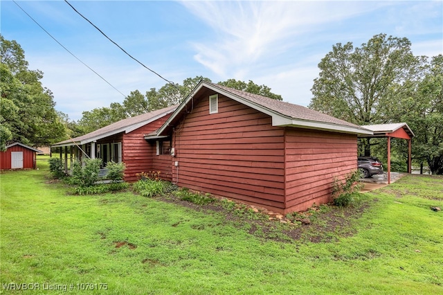 view of side of home featuring a storage shed, a lawn, and an outbuilding