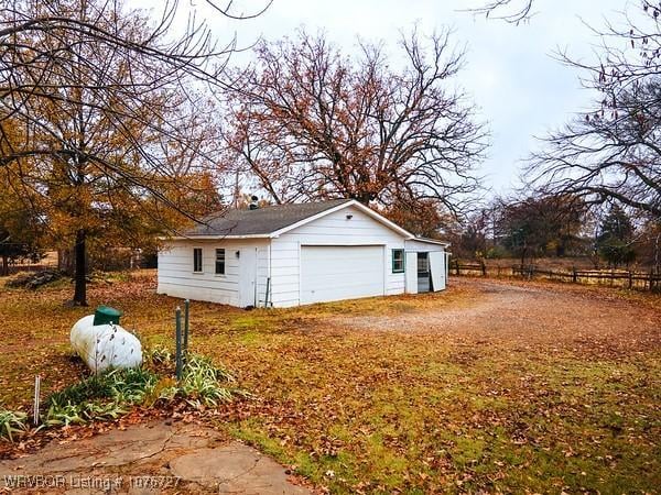 view of side of property featuring a garage and an outdoor structure