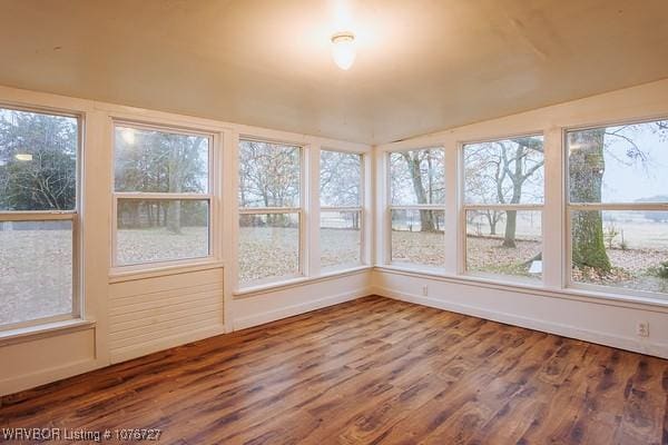 unfurnished sunroom with lofted ceiling