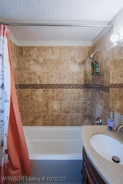 bathroom with vanity and shower / bathtub combination with curtain